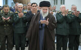 Iranian Supreme Leader Ayatollah Ali Khamenei, center, leads a prayer during his meeting with a group of senior military leaders, in Tehran, Iran, Sunday, April 21, 2024. (Office of the Iranian Supreme Leader via AP)