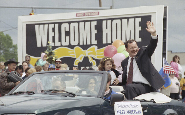 File - Former Hezbollah hostage Terry Anderson waves to the crowd as he rides in a parade in Lorain, Ohio, June 22, 1992. Anderson, the globe-trotting Associated Press correspondent who became one of America’s longest-held hostages after he was snatched from a street in war-torn Lebanon in 1985 and held for nearly seven years, died on April 21, 2024. He was 76. (AP Photo/Mark Duncan, File)