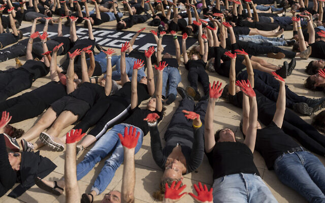 Family and supporters of hostages held in the Gaza Strip hold up their hands, painted red to symbolize blood, to call for the captives' release and to mark 200 days since the Hamas-led Oct. 7 cross-border attack, in Tel Aviv, Israel, Tuesday, April 23, 2024. (AP Photo/Ohad Zwigenberg) Family and supporters of hostages held in the Gaza Strip hold up their hands, painted red to symbolize blood, to call for the captives' release and to mark 200 days since the Hamas-led Oct. 7 cross-border attack, in Tel Aviv, Israel, Tuesday, April 23, 2024. (AP Photo/Ohad Zwigenberg)