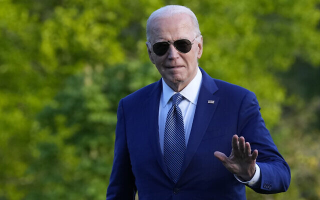 US President Joe Biden waves as he walks across the South Lawn of the White House in Washington, April 23, 2024. (AP Photo/Susan Walsh)