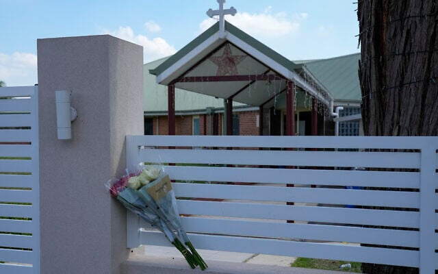 Flowers sit on a fence outside the Christ the Good Shepherd church in suburban Wakely in western Sydney, Australia, on April 16, 2024. (AP Photo/Mark Baker, File)