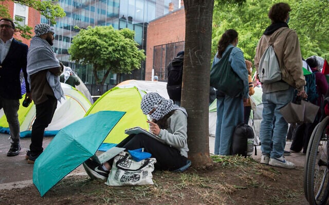 A George Washington University student works on a school assignment while joining other students in protests at George Washington University in Washington,, April 27, 2024. Pro-Palestinian, anti-Israel protests and encampments have sprung up on college and university campuses across the country. (AP Photo/Cliff Owen) A George Washington University student works on a school assignment while joining other students in protests at George Washington University in Washington,, April 27, 2024. Pro-Palestinian, anti-Israel protests and encampments have sprung up on college and university campuses across the country. (AP Photo/Cliff Owen)