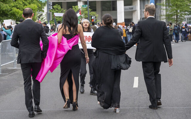 A demonstrator protests as guests arrive at the White House Correspondents Association Dinner at the Washington Hilton on April 27, 2024, in Washington. (AP Photo/Kevin Wolf)