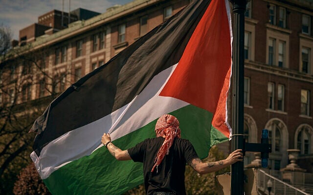 A protester places a Palestinian flag at the anti-Israel encampment at Columbia University, in New York City, April 28, 2024. (AP Photo/Andres Kudacki) A protester places a Palestinian flag at the anti-Israel encampment at Columbia University, in New York City, April 28, 2024. (AP Photo/Andres Kudacki)