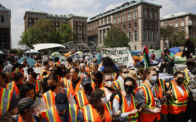 Columbia University faculty and staff gather on the campus in solidarity with student protesters who are demonstrating against the university's investments in Israel, April 29, 2024, in New York.  (AP Photo/Stefan Jeremiah)