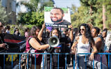 Family members and supporters of Solomon Tekah protest as Haifa Magistrate's Court Judge Zaid Falah and the policeman accused of negligent manslaughter in Tekah's death visit the scene of the incident in Haifa, December 15, 2022. (Shir Torem/Flash90)