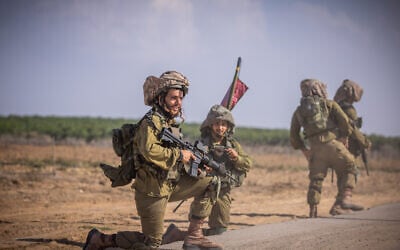 Israeli soldiers from the Netzah Yehuda Battalion patrol near the Israeli-Gaza border, October 20, 2023. (Yonatan Sindel/Flash90)