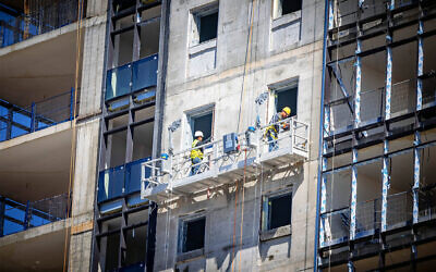 Illustrative: View of workers in a construction site in Jerusalem, March 5, 2024 (Yonatan Sindel/Flash90)
