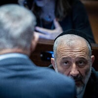 Knesset member Aryeh Deri looks at Prime Minister Benjamin Netanyahu during a vote on the state budget at the Knesset in Jerusalem, March 13, 2024. (Yonatan Sindel/ Flash90)