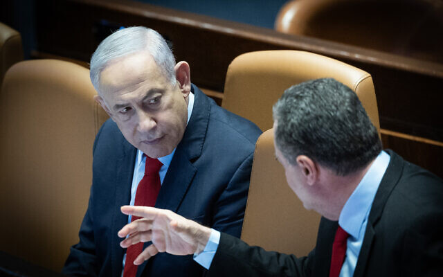 Prime Minister Benjamin Netanyahu speaks with Foreign Minister Israel Katz during a vote on the state budget at the Knesset in Jerusalem, March 13, 2024. (Yonatan Sindel/Flash90) Prime Minister Benjamin Netanyahu speaks with Foreign Minister Israel Katz during a vote on the state budget at the Knesset in Jerusalem, March 13, 2024. (Yonatan Sindel/Flash90)