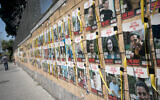 Posters of Israelis held hostage by Hamas are seen on the wall of the Defense Ministry in Tel Aviv, April 3, 2024. (Miriam Alster/Flash90)
