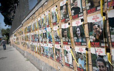 Posters of Israelis held hostage by Hamas are seen on the wall of the Defense Ministry in Tel Aviv, April 3, 2024. (Miriam Alster/Flash90)