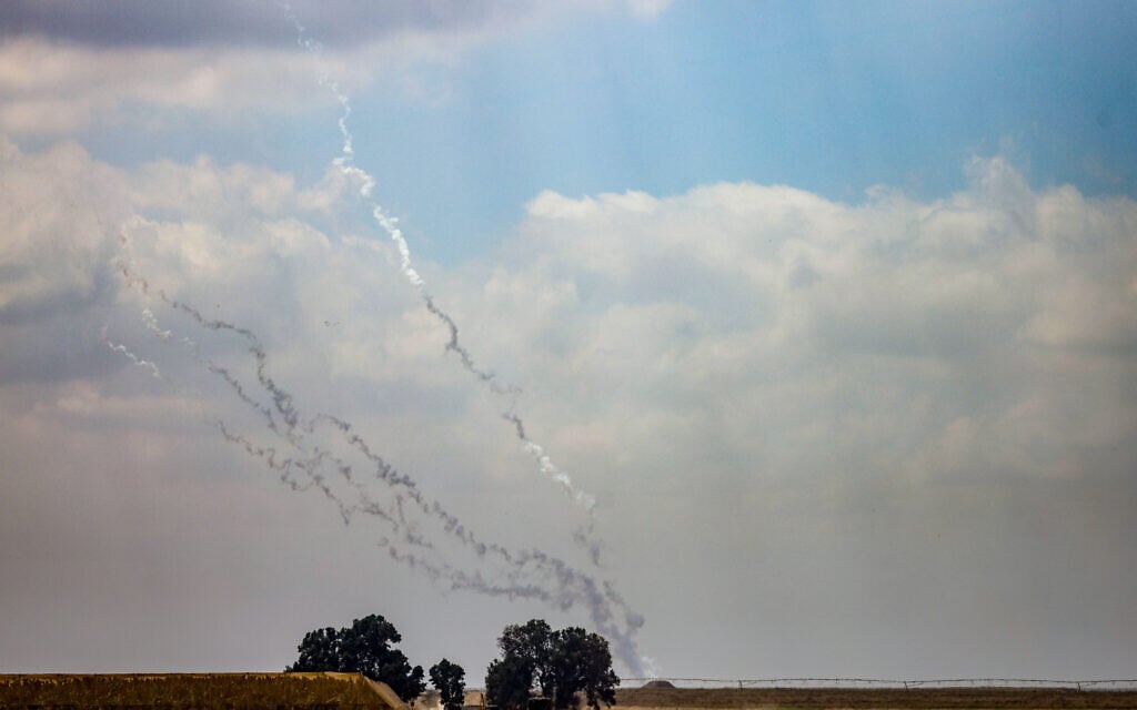 Smoke trails from rockets fired by Gaza terror groups as seen from the Israeli side of the border, April 7, 2024. (Chaim Goldberg/Flash90)