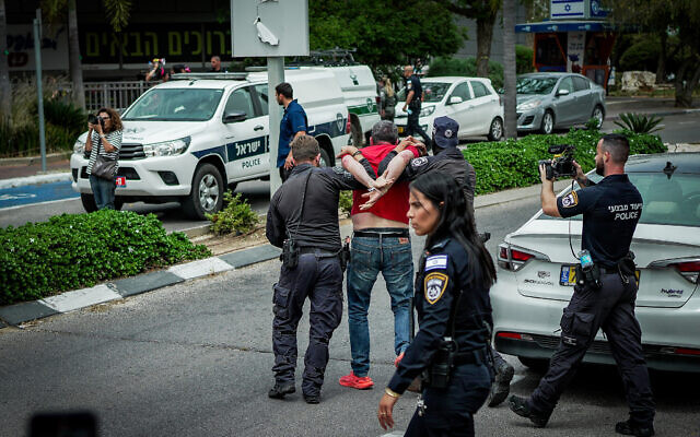 Police detain a demonstrator outside the home of war cabinet minister Benny Gantz, calling on him to resign from the emergency government, Rosh Ha'ayin, April 26, 2024. (Erik Marmor/Flash90) Police detain a demonstrator outside the home of war cabinet minister Benny Gantz, calling on him to resign from the emergency government, Rosh Ha'ayin, April 26, 2024. (Erik Marmor/Flash90)