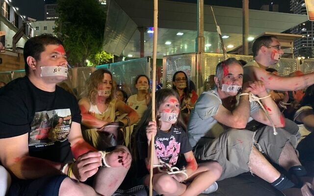 Relatives of the hostages held captive in Gaza sit at the entrance to Tel Aviv's Kirya military base marking 200 days since October 7 on April 23, 2024. (Charlie Summers/Times of Israel) Relatives of the hostages held captive in Gaza sit at the entrance to Tel Aviv's Kirya military base marking 200 days since October 7 on April 23, 2024. (Charlie Summers/Times of Israel)