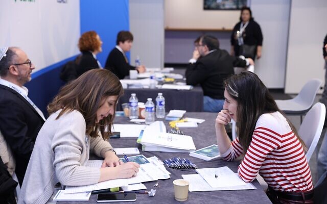 An Israeli representative engages with a French health worker at Europe's first-ever MedEx immigration expo for medical professionals in Paris, March 31, 2024. (Courtesy of Nefesh B'Nefesh)