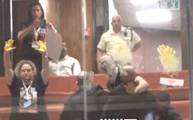 Relatives of hostages protest in the Knesset, painting their hands yellow, on April 3, 2024 (Knesset channel video screenshot; used in accordance with Clause 27a of the Copyright Law) Relatives of hostages protest in the Knesset, painting their hands yellow, on April 3, 2024 (Knesset channel video screenshot; used in accordance with Clause 27a of the Copyright Law)