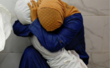 This image provided by World Press Photo and taken by Mohammed Salem of the Reuters news agency won the World Press Photo Award of the Year and shows Palestinian woman Inas Abu Maamar, 36, embracing the body of her 5-year-old niece Saly, at Nasser hospital in Khan Younis in the southern Gaza Strip, October 17, 2023. (Mohammed Salem/Reuters/World Press Photo via AP)