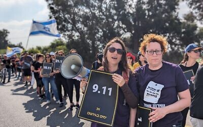 Participants in the Let My People Go march hold posters of all the dates that the hostages have been held in captivity by Hamas in Gaza, on April 12, 2024. (Tanya Zion-Waldoks)