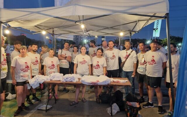 Runners in the Tel Aviv Night Run on April 17, 2024, racing for hostage Evyatar David, taken from the Supernova desert rave (Courtesy) Runners in the Tel Aviv Night Run on April 17, 2024, racing for hostage Evyatar David, taken from the Supernova desert rave (Courtesy)