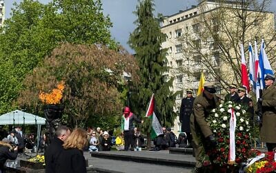 A pro-Palestinian protester takes the stage briefly at the official ceremony to commemorate the 81st anniversary of the Warsaw Ghetto Uprising in Poland, April 19, 2024. (Gabe Miner via JTA)