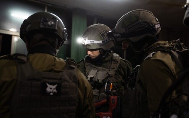 IDF soldiers measure the home of a terrorist who carried out a deadly stabbing attack in Gan Yavne earlier this week, ahead of its potential demolition, in the southern west Bank town of Dura, March 5, 2024. (Israel Defense Forces) IDF soldiers measure the home of a terrorist who carried out a deadly stabbing attack in Gan Yavne earlier this week, ahead of its potential demolition, in the southern west Bank town of Dura, March 5, 2024. (Israel Defense Forces)
