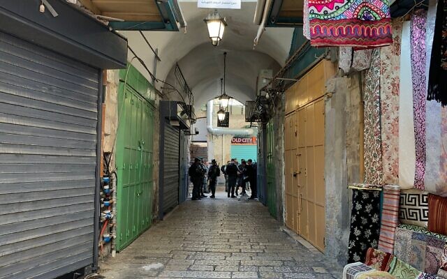 Israeli border police tightly patrol the street separating the Jewish and Muslim Quarters of Jerusalem's Old City as thousands of Jewish worshipers convene at the Western Wall for the Passover priestly blessing. (Charlie Summers/Times of Israel)
