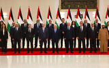 Palestinian Authority President Mahmoud Abbas poses for a picture with his new government, after it was sworn in on March 31, 2024, in Ramallah, in the West Bank. Finance Minister Omar Bitar is standing third from the left in the front row. (Jaafar ASHTIYEH / AFP)