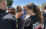 A supporter of National Security Minister Itamar Ben Gvir yells at a protester outside the Ashdod military cemetery following a Memorial Day ceremony on May 13, 2024. (Sam Sokol/Times of Israel)