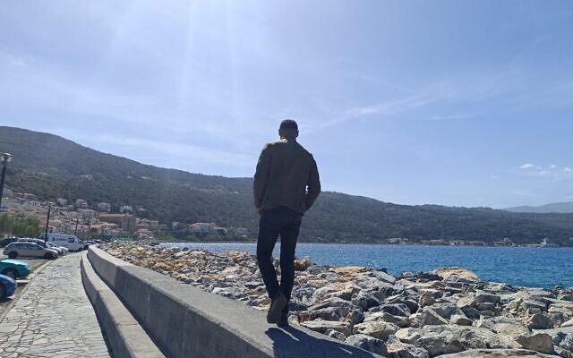 'Mohammed,' an asylum seeker from Gaza, stands on the port of Samos in Greece on April 17, 2024. (Eliyahu Freedman/Times of Israel)