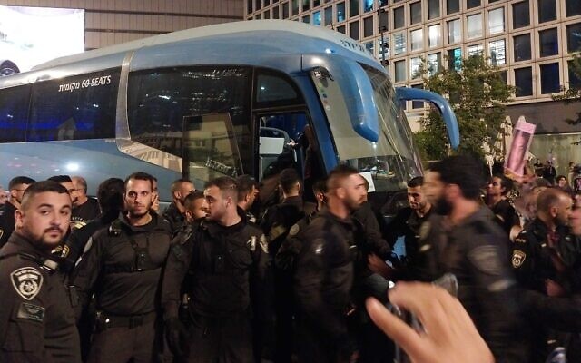 Police escort a detainee unto a bus at the anti-government protest in Tel Aviv, May 11, 2024. (Iddo Schejter/Times of Israel) Police escort a detainee unto a bus at the anti-government protest in Tel Aviv, May 11, 2024. (Iddo Schejter/Times of Israel)