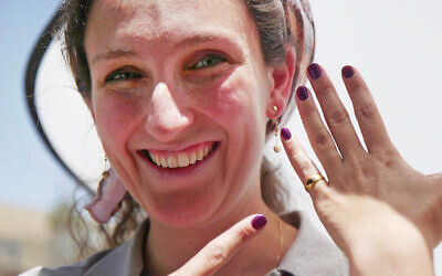 Rikki Zalut Har-Tuv of the IAA displays a Hellenistic-era, 2,300-year-old gold ring found in the City of David in Jerusalem, in an image released on May 27, 2024. (Emil Aladjem/IAA)