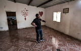 Mohamad Hassouna, who resides in the unrecognized Bedouin village of Al-Fura, stands in a building near where his 7-year-old daughter Amina was injured by an Iranian missile shard in the southern Negev desert on April 14, 2024. (Ahmad Gharabli/AFP)