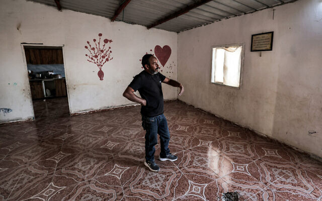 Mohamad Hassouna, who resides in the unrecognized Bedouin village of Al-Fura, stands in a building near where his 7-year-old daughter Amina was injured by an Iranian missile shard in the southern Negev desert on April 14, 2024. (Ahmad Gharabli/AFP) Mohamad Hassouna, who resides in the unrecognized Bedouin village of Al-Fura, stands in a building near where his 7-year-old daughter Amina was injured by an Iranian missile shard in the southern Negev desert on April 14, 2024. (Ahmad Gharabli/AFP)