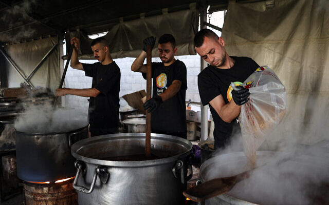 Illustrative - Local volunteers of the World Central Kitchen cook meals to be distributed to displaced Palestinians in Rafah in the southern Gaza Strip on May 3, 2024. (Photo by AFP) Illustrative - Local volunteers of the World Central Kitchen cook meals to be distributed to displaced Palestinians in Rafah in the southern Gaza Strip on May 3, 2024. (Photo by AFP)