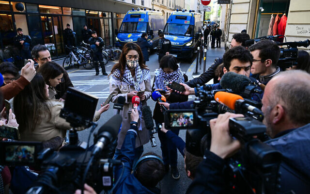 Members of Palestine Action Committee (Comite Action Palestine) speak to journalists near the entrance of the Institute of Political Studies (Sciences Po Paris) which has been occupied by pro-Palestinian students, Paris, May 3, 2024.(Migual Medina/AFP)