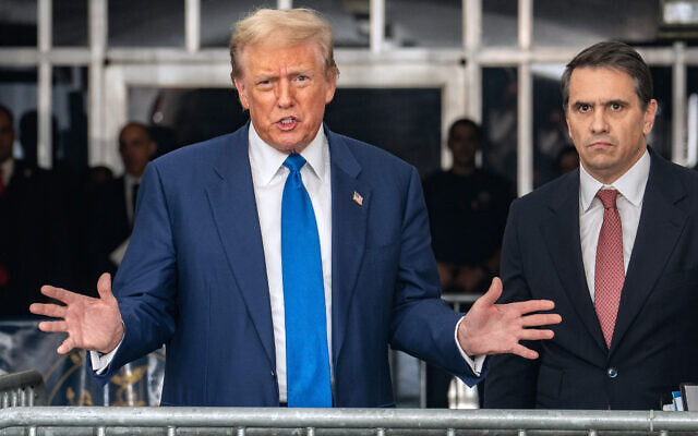 Former US President and Republican presidential candidate Donald Trump talks to reporters, alongside attorney Todd Blanche (R) at the end of the day's proceedings in his criminal trial at the New York State Supreme Court in New York City, on May 3, 2024 (Jeenah Moon/Pool/AFP)