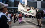 Anti-Israel student protesters hang a banner reading in French, "Free Palestine from the Sea to the Jordan River," during a demonstration at Lausanne University in Switzerland on May 4, 2024. (Fabrice Coffrini/AFP)