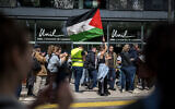 Pro-Palestinian student protesters and activists attend a demonstration at the entrance of Lausanne University's (UNIL) Geopolis building, occupied by anti-Israel students, in Lausanne on May 4, 2024. (Fabrice COFFRINI / AFP)