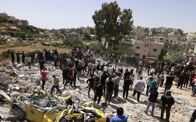 Palestinians inspect the damage after a counter-terror raid by Israeli forces in the northern West Bank town of Dayr al-Ghusun, near Tulkarem, on May 4, 2024. (Jaafar Ashtiyeh/AFP)