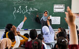 File: A woman instructs children on arithmetic multiplication in a classroom at a school run by the United Nations Relief and Works Agency for Palestine Refugees in the Near East (UNRWA) at the Shati camp for Palestinian refugees, west of Gaza City, on May 7, 2024. (AFP)