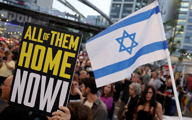 Relatives and supporters of hostages taken captive by Palestinian terrorists in Gaza during the October 7 attacks, hold placards during a demonstration calling for their release, in Tel Aviv on May 9, 2024. (Jack Guez/AFP)
