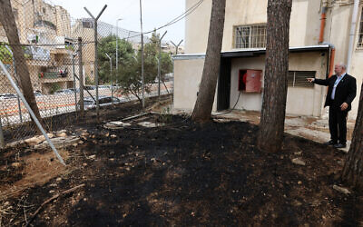 United Nations Relief and Works Agency for Palestine Refugees (UNRWA) Affairs Director in the West Bank Adam Bouloukos visits the agency's headquarters in east Jerusalem, where the traces of a fire are visible after "Israeli extremists" allegedly set ablaze the perimeter of the building on May 10, 2024. (AHMAD GHARABLI / AFP)