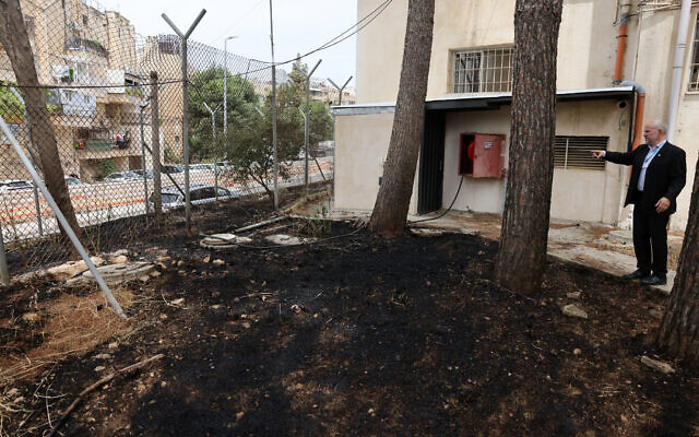 United Nations Relief and Works Agency for Palestine Refugees (UNRWA) Affairs Director in the West Bank Adam Bouloukos visits the agency's headquarters in east Jerusalem, where the traces of a fire are visible after "Israeli extremists" allegedly set ablaze the perimeter of the building on May 10, 2024. (AHMAD GHARABLI / AFP) United Nations Relief and Works Agency for Palestine Refugees (UNRWA) Affairs Director in the West Bank Adam Bouloukos visits the agency's headquarters in east Jerusalem, where the traces of a fire are visible after "Israeli extremists" allegedly set ablaze the perimeter of the building on May 10, 2024. (AHMAD GHARABLI / AFP)