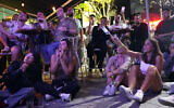 People watch the final results of the 68th Eurovision Song Contest (ESC) 2024 at a bar in Tel Aviv on May 12, 2024. (Sharon Aronowicz/AFPTV/AFP)
