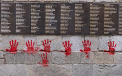 Red hands graffitis are seen on the "Wall of the Righteous" (Mur des Justes), in Paris, France, on May 14, 2024. (Antonin UTZ / AFP)
