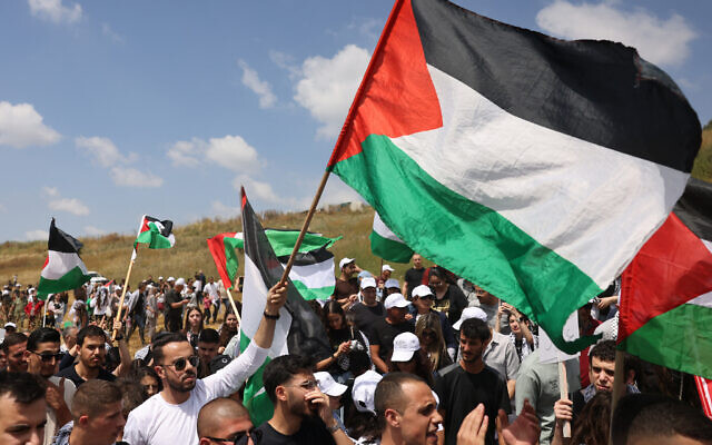 Arab-Israelis wave Palestinian flags during the annual "March of Return," near the northern town Shfaram on May 14, 2024. (Ahmad Gharabli/AFP)
