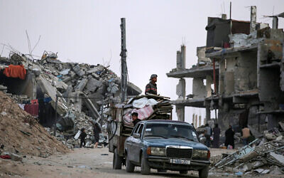 Palestinians who fled Rafah in the southern Gaza Strip arrive with their belongings in Khan Younis on May 15, 2024. (AFP)