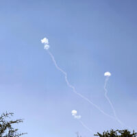 Illustrative - Rockets fired from southern Lebanon are intercepted by Israel's Iron Dome air defense system over the Golan Heights on May 16, 2024. (Jalaa Marey/AFP)