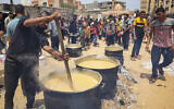 Volunteers prepare food for displaced Palestinians in Rafah, in the southern Gaza Strip, on May 19, 2024. (AFP)